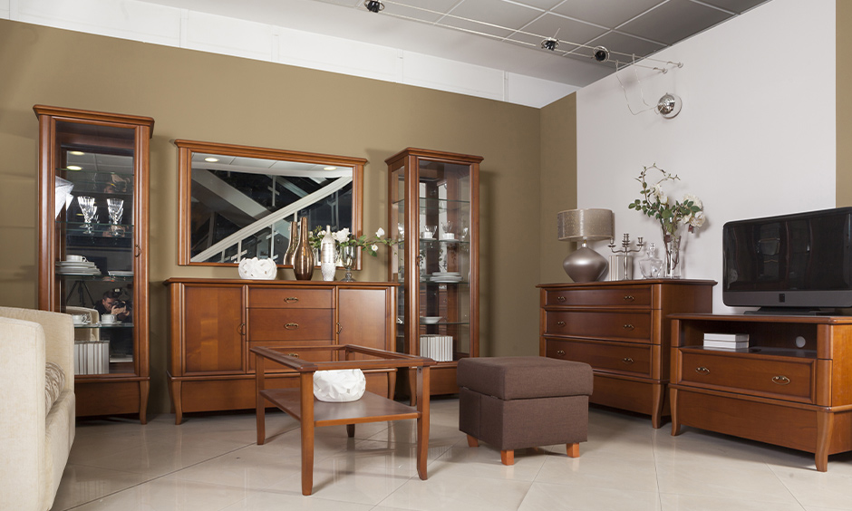 Wooden Almirah design for Living room with rectangular wooden framed mirror.